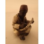 Cold painted bronze of boy reading after