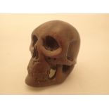 Oriental carved wood skull with incised