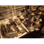 Shelf of silver plated flatware a candelabra and a three piece insulated tea service