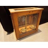 Set of wooden cased scientific scales with weights marked James Woolley & Sons