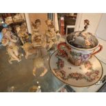 Collection of ceramic cherub and putti figurines and a cherub decorated hot chocolate cup