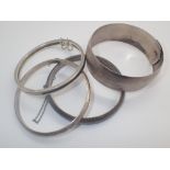 Three silver bangles 41g and a white metal example