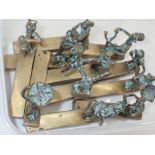 Eleven African figural brass knife stands