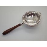 Hallmarked silver tea strainer with a turned wood handle assay Birmingham 1927