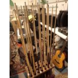 Twenty three snooker cues with stand