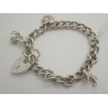 Hallmarked silver bracelet with three charms 34g