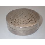 Unmarked white metal circular box with engraved celtic design to lid