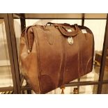 Brown leather briefcase with contents of vintage leather driving gloves caps etc