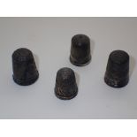 Four hallmarked silver thimbles various assay and makers marks