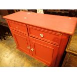 Modern pine two drawer over a double door cupboard painted pink 107 x 88 x 42 cm