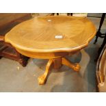 Circular golden oak table with three claw feet H: 54 cm