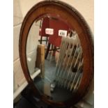 Oak framed bevelled edge oval mirror