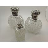 Pair of Victorian cut glass hallmarked silver top perfume bottles and a cut glass silver top