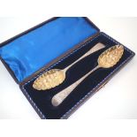 Matched pair of silver George II berry spoons in a fitted box