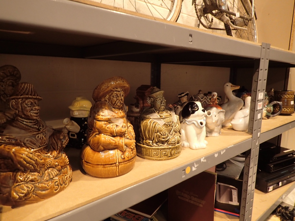 Two shelves of teapots sugar and coffee containers by Sadler and Sylvac etc