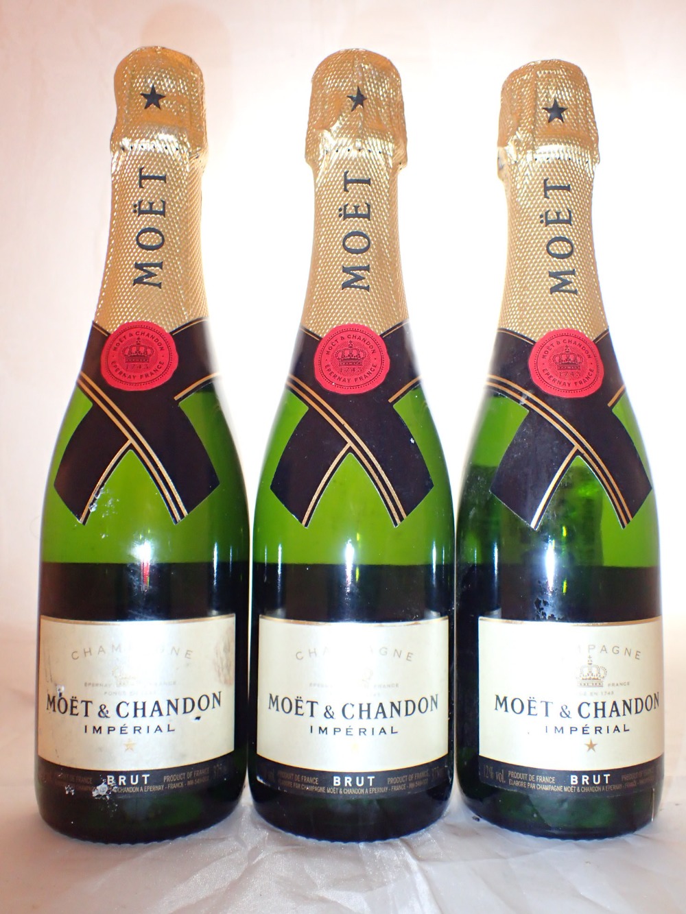 Three half bottles of Moet & Chandon NV Champagne racked and cellared