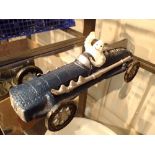 Cast iron Michelin Man in racing car H: 26 cm