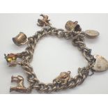 Hallmarked silver bracelet with padlock clasp and eight charms