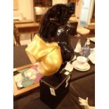 Modern sculpture in black and gold of a female bust on black granite base H: 45 cm