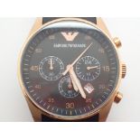 Emporio Armani black faced gents wristwatch with rose gold coloured surround on a black rubber and