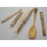 Two heavily carved antique ivory cigarette holders one A/F ivory crocodile and a bone spoon