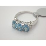 Previously owned but unused 9ct white gold three stone paraiba tourmaline ring with diamond set