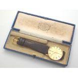 Mappin and Webb 9 ct yellow gold mechanical wristwatch with Roman numeral chapter ring on a leather