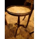 Walnut tripod wine table with a galleried marble top and ormulu mounts