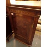 19thC parquetry inlaid mahogany wall hanging cupboard having a carved profile of a swan applied to