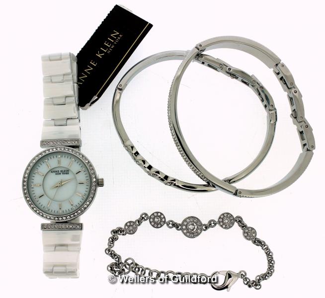 *Ladies' Anne Klein wristwatch, circular white dial with white stone set bezel, white strap,