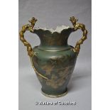 An ornate Victorian vase, the twin handles formed as dragons, the green body gilt-heightened with