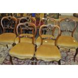 A set of six Victorian walnut salon chairs with pierced cresting rails and cabriole legs.