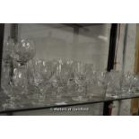 A shelf of stemware including Stuart and other makes: tumblers, hock glasses, wines, etc.