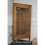 Continental corner cabinet with single glazed door enclosing glass shelves