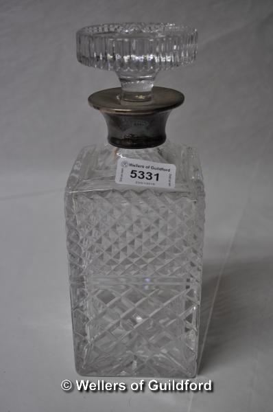 A cut glass square decanter with silver collar, marks rubbed.