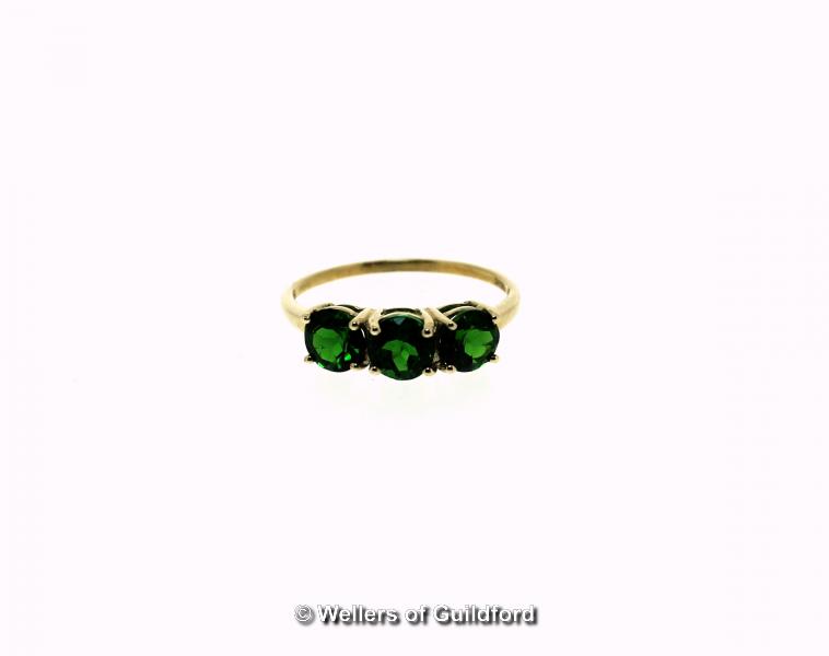 Chrome diopside three stone ring, three round cut chrome diopsides, weighing an estimated total of