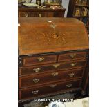 A George IV crossbanded mahogany bureau, the fall flap with floral inlay, over two short and three