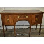 A George III crossbanded mahogany sideboard woth central drawer flanked by cupboard and