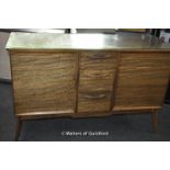 A retro walnut sideboard by Handcraft Quality Furniture, with three central drawers flanked by