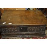 An early 18th Century oak bible box with plain top and carved front.