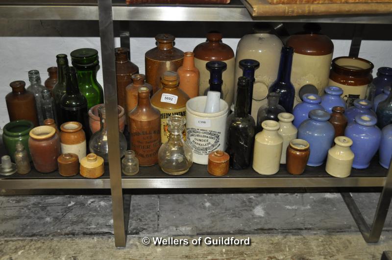 A large quantity of stoneware and glass bottles.