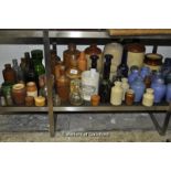 A large quantity of stoneware and glass bottles.