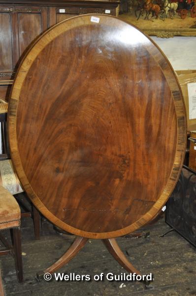 A George IV crossbanded oval mahogany tilt top breakfast table on tripod support, 120 x 91cm.