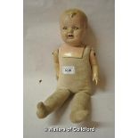 A composition shoulder head doll with composition arms, straw stuffed body and legs.