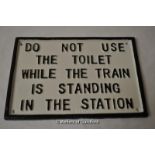 *Railway sign "Do not use the toilet while the train is standing in the station", 25x16.5cm (Lot