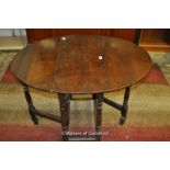 A small period oak oval gateleg table on turned supports