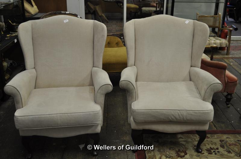 Pair of cream wingback armchairs