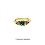 Three stone emerald and diamond ring, central emerald cut emerald with a round brilliant cut diamond