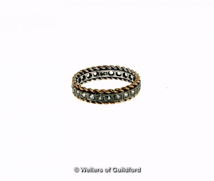 Eternity ring set with white paste stones, with rope design edging, mounted in yellow and white