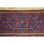 A modern Turkish red and blue rug, 183 x 105cm.